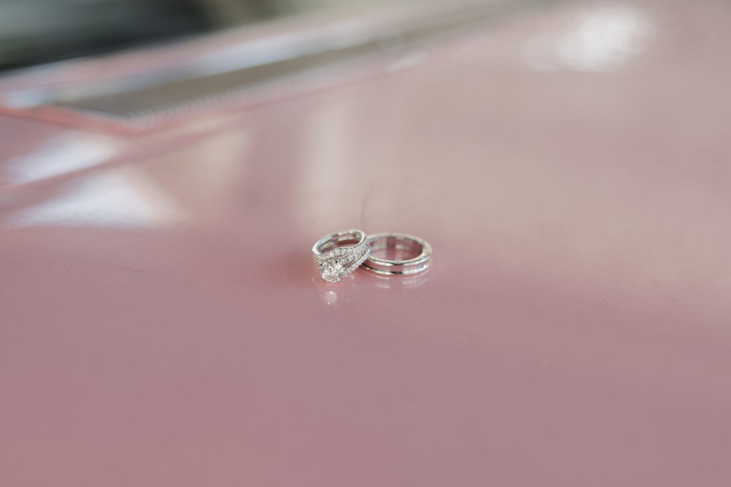 wedding ring detail shot on pink Cadillac 