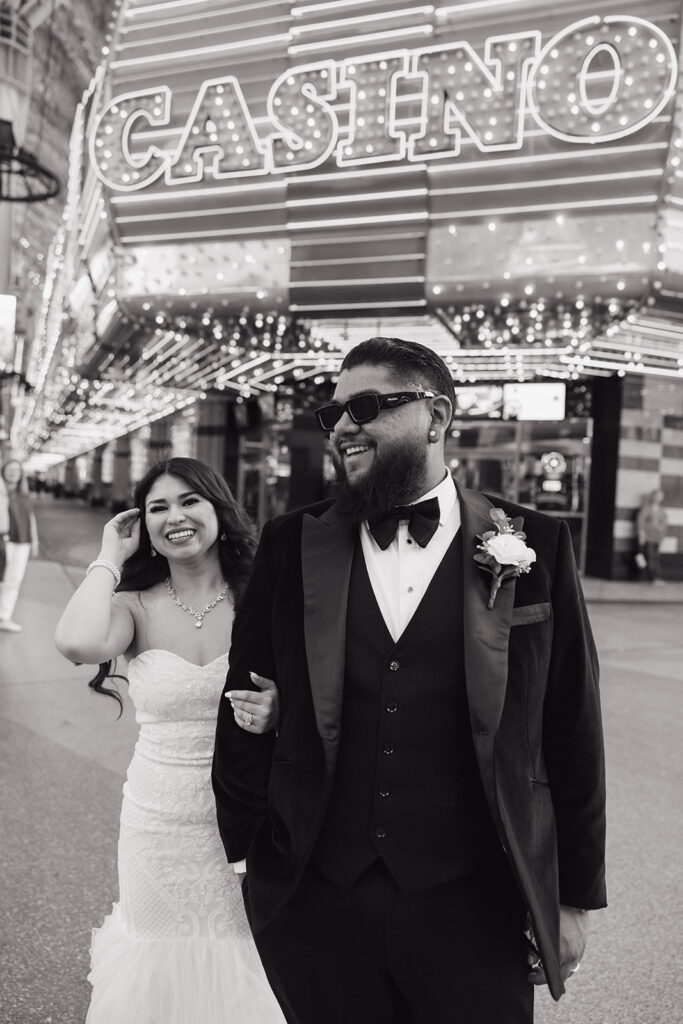bride and groom walking downtown fremont street