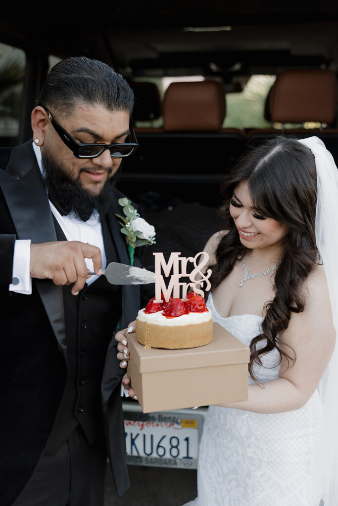 bride and groom cutting cake during their elopement
